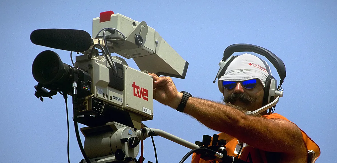 Television camera operator framing a shot on a broadcast camera